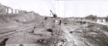 Exccavation of oulet and spillway. Workers in centre and to the right of image.