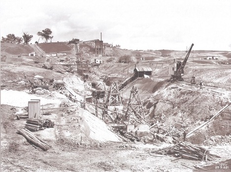 Excavation for core wall in foreground and earth embankment in background
