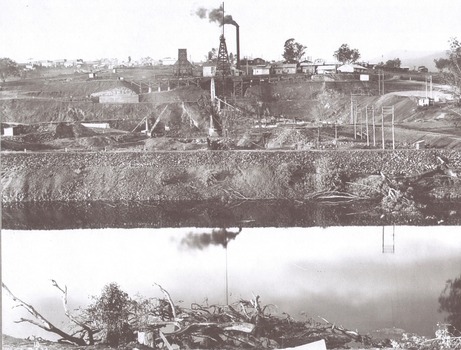 In the foreground, a levee bank with connecting wings back to higher ground