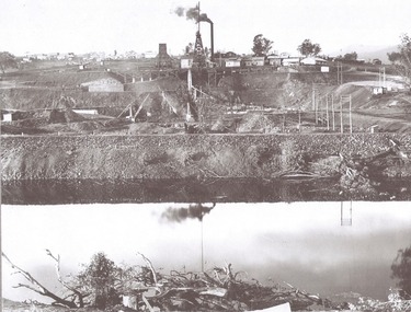 In the foreground, a levee bank with connecting wings back to higher ground