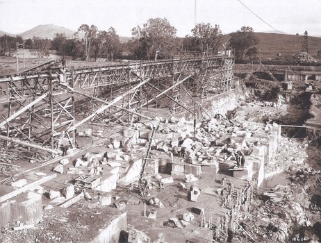 Foundation work and dam construction proceeding inside levee bank which may be seen at the right hand end of the work 