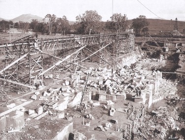 Foundation work and dam construction proceeding inside levee bank which may be seen at the right hand end of the work 