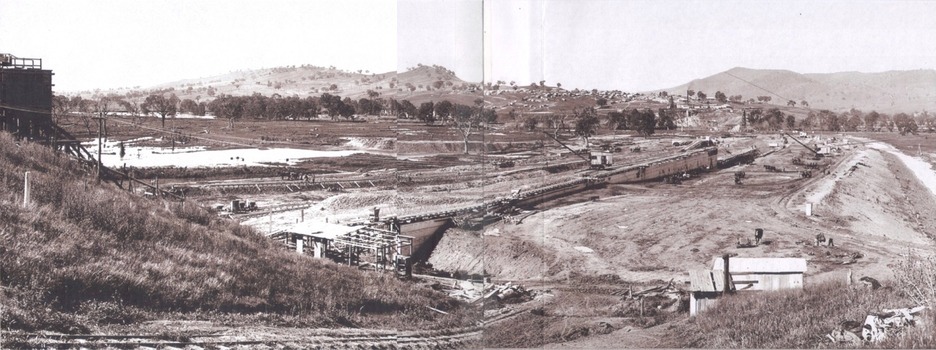 General view of earth embankment in Victoria and town in background 