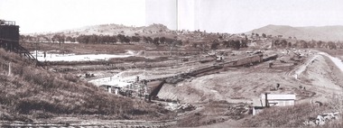 General view of earth embankment in Victoria and town in background 