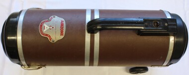 Cylindrical vacuum cleaner showing manufacturer's badge