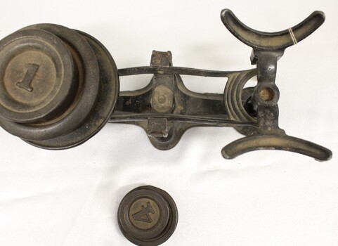 Metal balance scale with a set of imperial weights