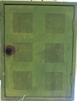 A meat safe painted green. 6 sets of vents in door.
