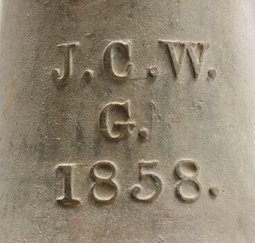 Letters and date inscribed on the side of the bell. 