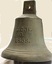 Large bell with letters and date inscribed on it.