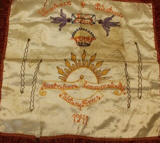 A silk cushion covered embroidered with emblem of the Australian Commonwealth Military Forces 1941.