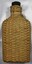 Glass bottle with rattan cover