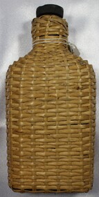 Glass bottle with rattan cover