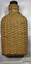 Bottle in rattan cover with scale