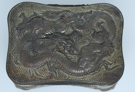 Top view of metal Jewellery box showing dragon design.