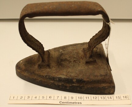 Small flat iron with scale in centimetres