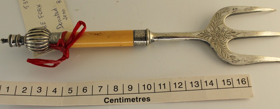 Silver cake fork with scale in centimetres