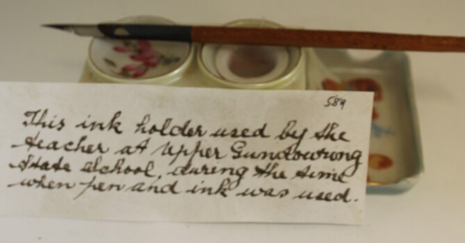 Pen and ink set showing ink pen with note.