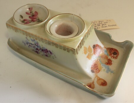 China pen and ink set with painted floral decorations.