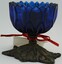 Blue glass pen wiper on metal base.