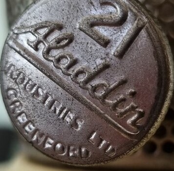 Wick adjustment knob bearing the model number 21 and the brand of Aladdin Industries.