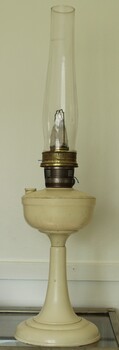 A white Bakelite Aladdin Kerosene lamp with pedestal and tall chimney