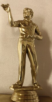 Figurine of darts player at base of trophy.