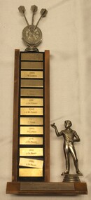 Terminus Dart Club SIngles Championship 1985 - 1992 Trophy with dart player figurine and darts and dart board on top.