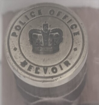 Seal from Belvoir Police Office - text in reverse