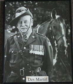 Des Martin in full military uniform with his horse in the background.