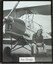 Joe Drage sitting on the wheel of his Tiger Moth 