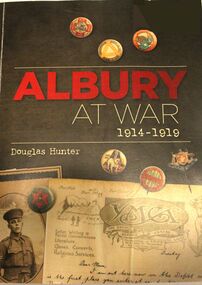 Front cover showing badges, a soldier and a letter.