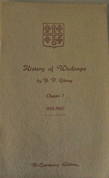 A small booklet bearing a coat of arms in red text.