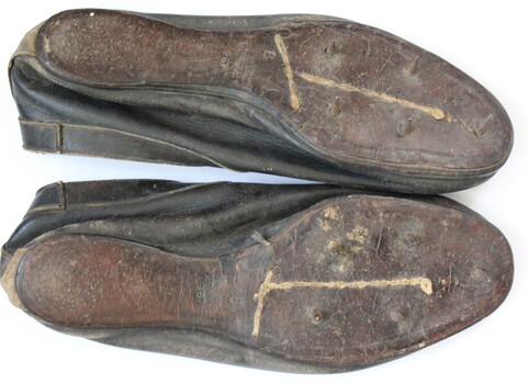Sole of running shoes showing spikes. 96 marked on sole.