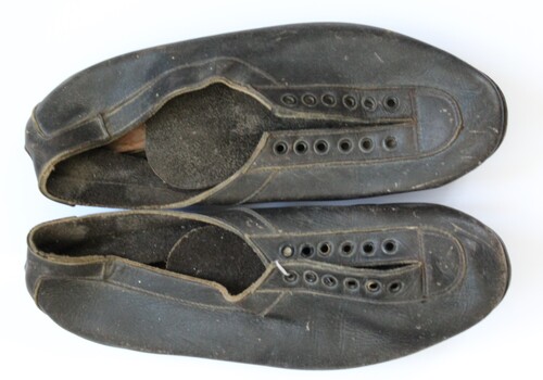 A pair of black leather running spikes