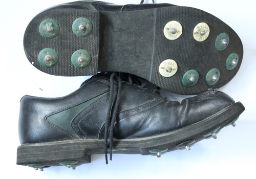Golf shoes showing soles and spikes