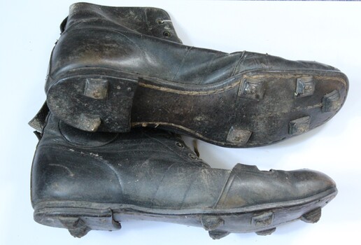 Leather football boots side and bottom showing stops.