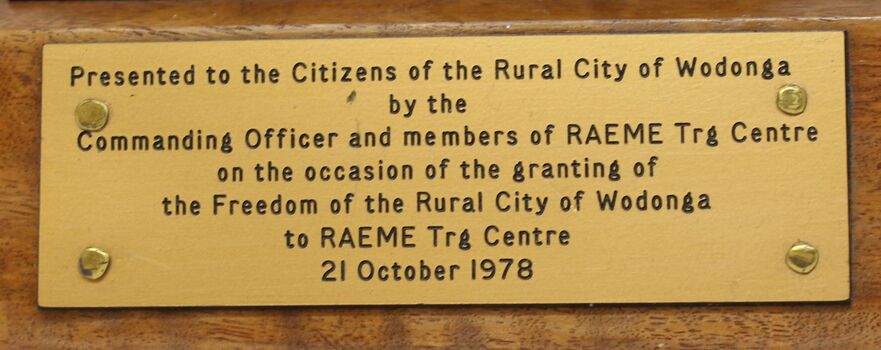 Dedication plaque on side of award base