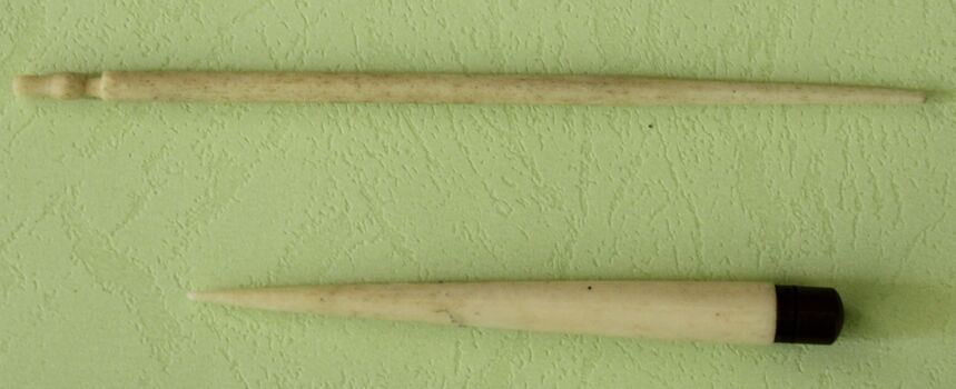 2 small ivory sticks, one with brass cap