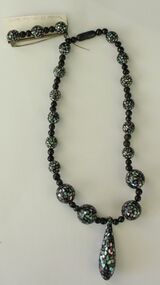 Necklace of round black beads with embedded opal chips