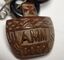 Central pendant reverse side with inscription AMM