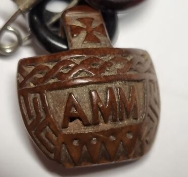 Central pendant reverse side with inscription AMM
