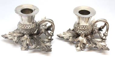 A pair of metal thistle shaped chamber sticks