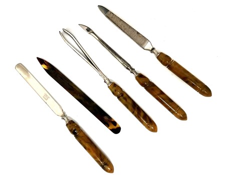 Manicure set items including nail file, tweezers and shaping tools