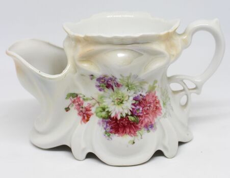 A porcelain shaving mug with a floral design