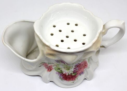 Top view of shaving mug showing cavity for brush and draining holes