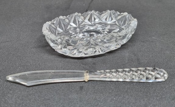 A crystal cut butter dish and knife