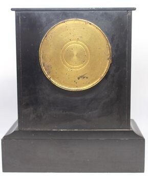 Back of clock with central door covering internal mechanism