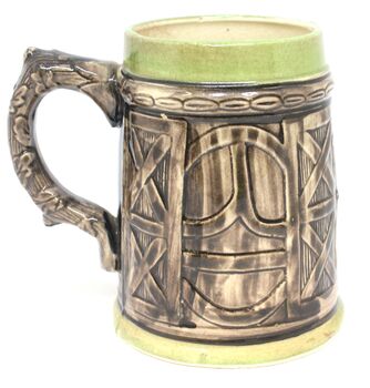 Reverse of beer mug with door / shield design and green trim at base and lip.