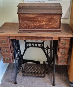 Full front view of sewing machine showing "Coffin Top" and table 