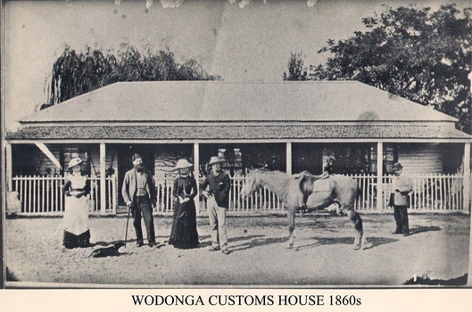Customs officer and family outside the cottage